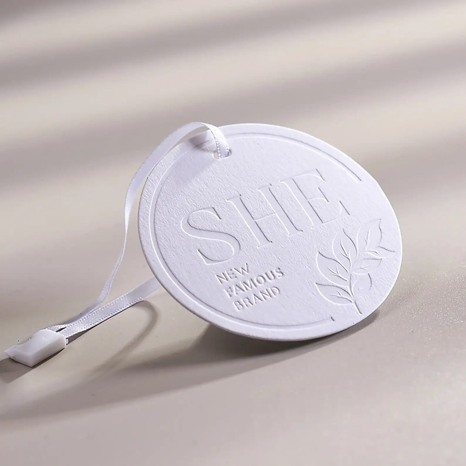 

Custom White Circle Paper Hang Tags 500pcs Embossing Swing tag clothing tag with ribbon string Simple Tag Personalized Tag Round