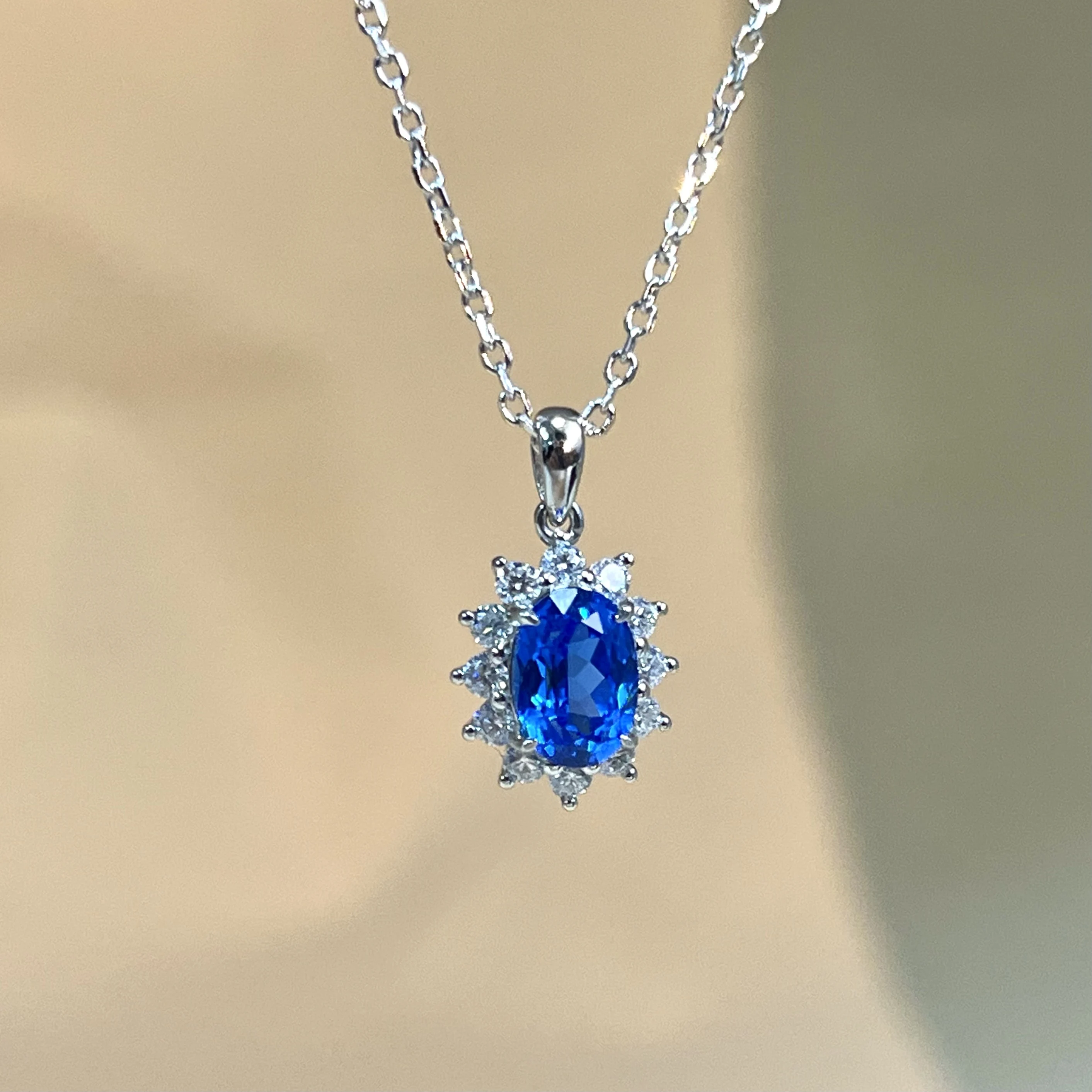 S925 sterling silver cultured sapphire necklace with classic everyday surround-set diamond pendant design.