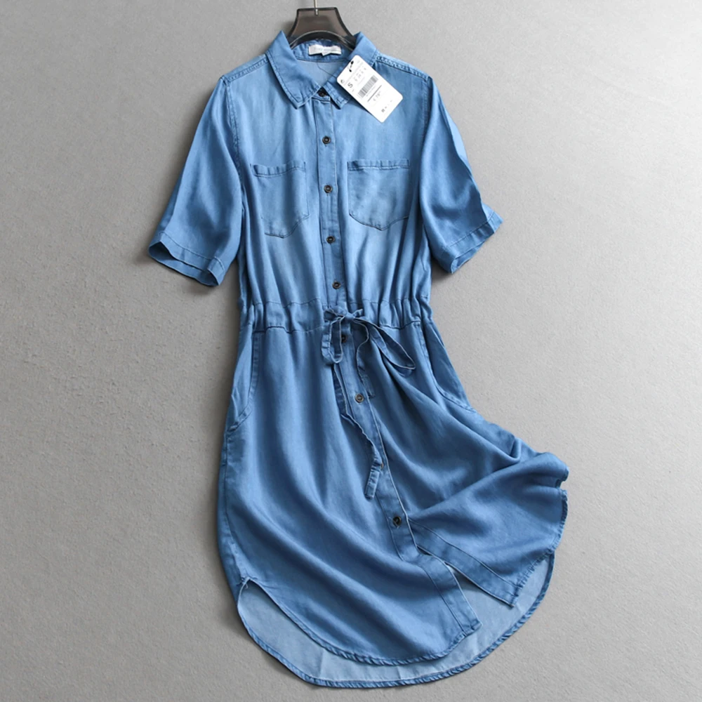 ชุดเดรสยีนส์สีทึบลําลองผู้หญิงกระดุมแถวเดียวออกแบบกระเป๋าสมมาตรสายรัดกระชับสัดส่วนชุดเสื้อเชิ้ตอเนกประสงค์