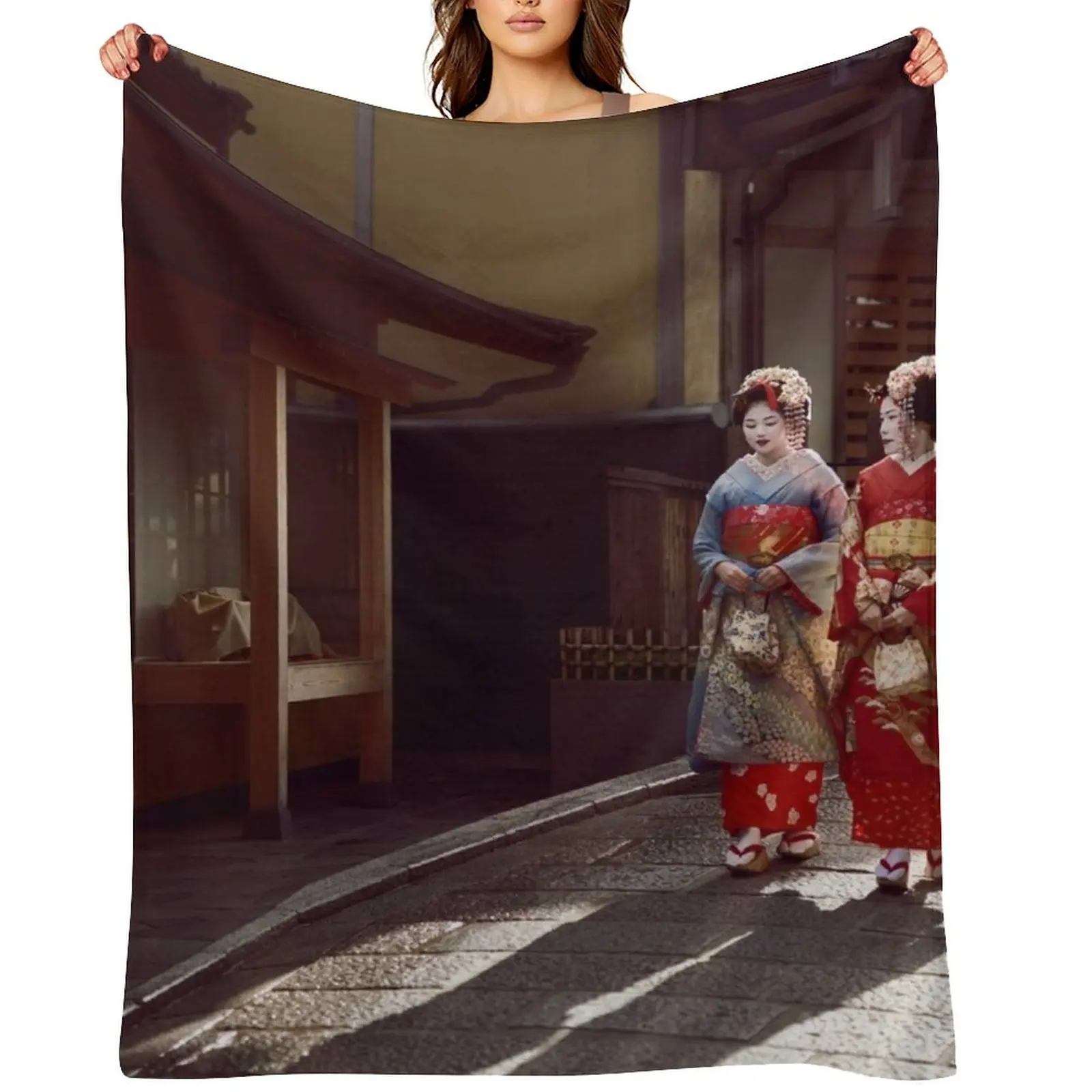 

Two Geisha apprentices Maiko in bright kimono walking down an old street in Kyoto Japan art photo print Throw Blanket