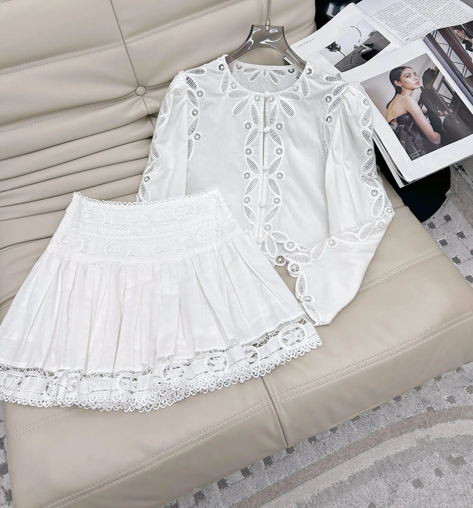 

2025 spring and summer new women's fashion suit hollow embroidery button small top + high waist skirt two-piece set 0224
