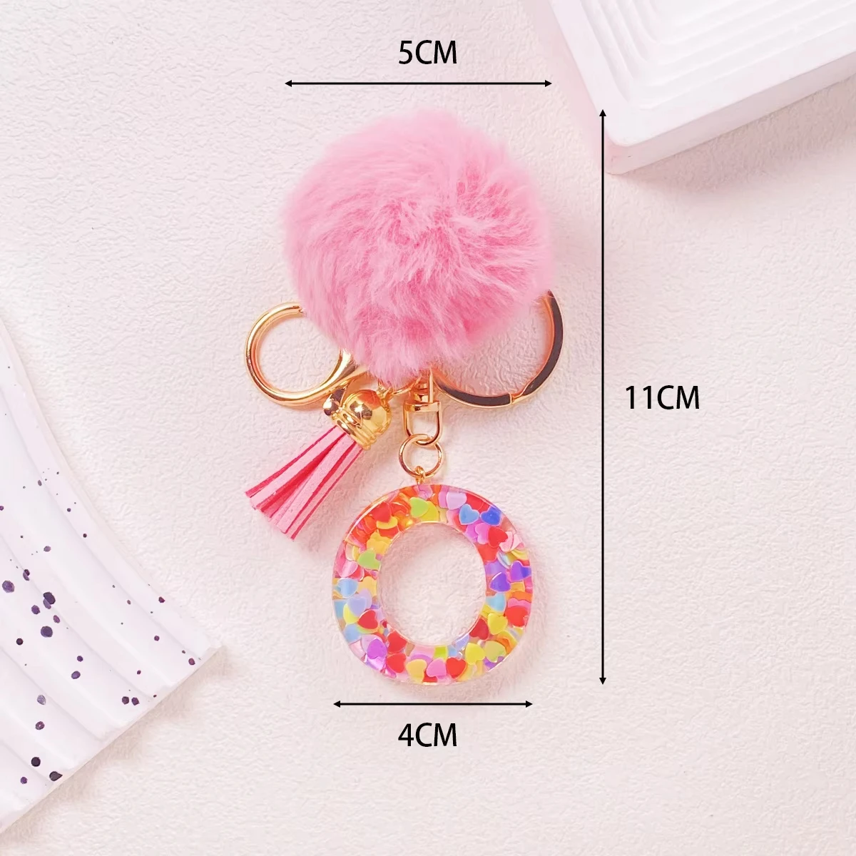 One-piece acrylic pink pom-pom glitter A-Z letter keychain, perfect as a gift for Christmas, birthdays, or friends and family.