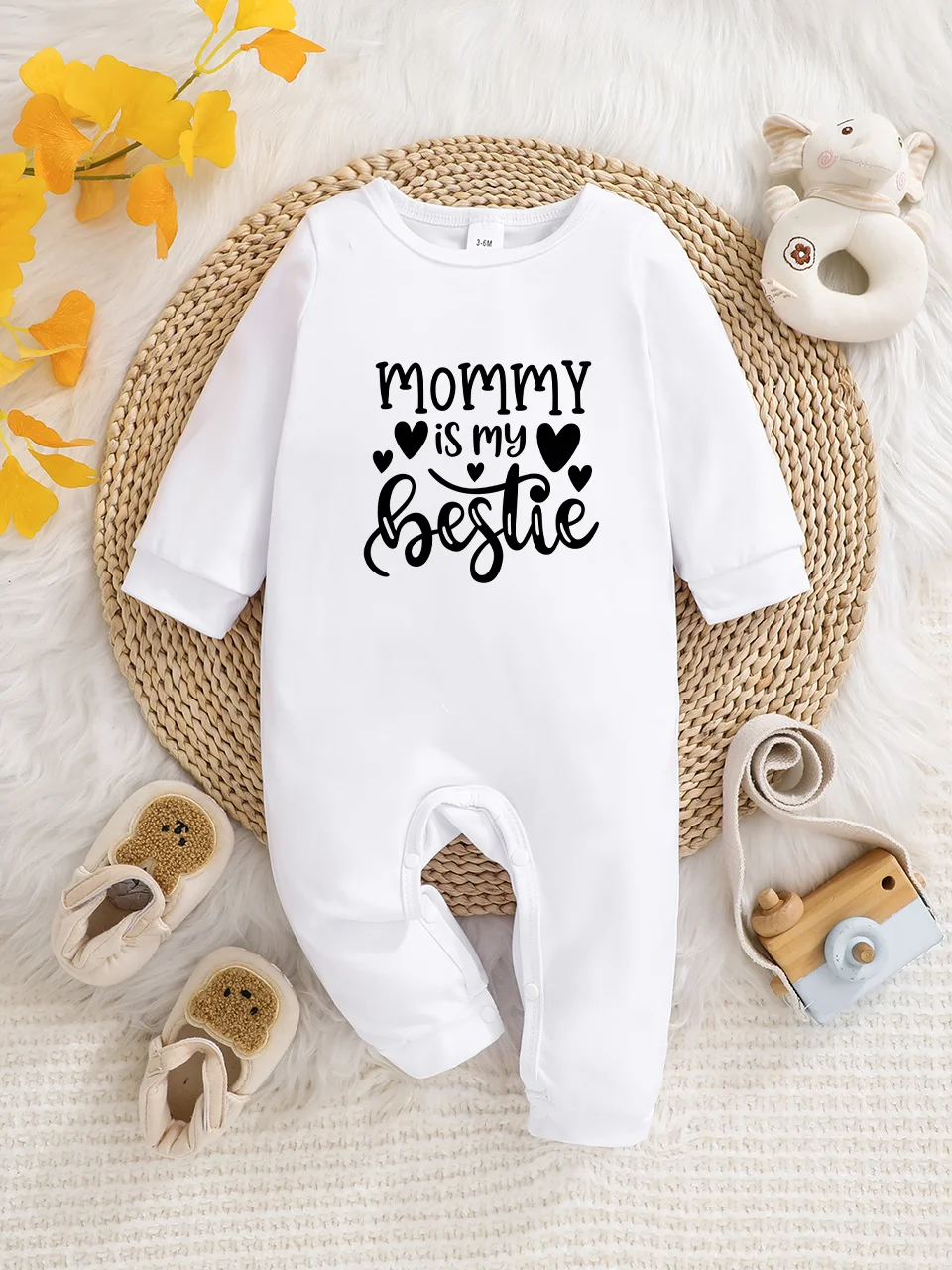 A baby long-sleeved onesie with interesting letter prints. It features a buttoned design for easy putting on and taking off