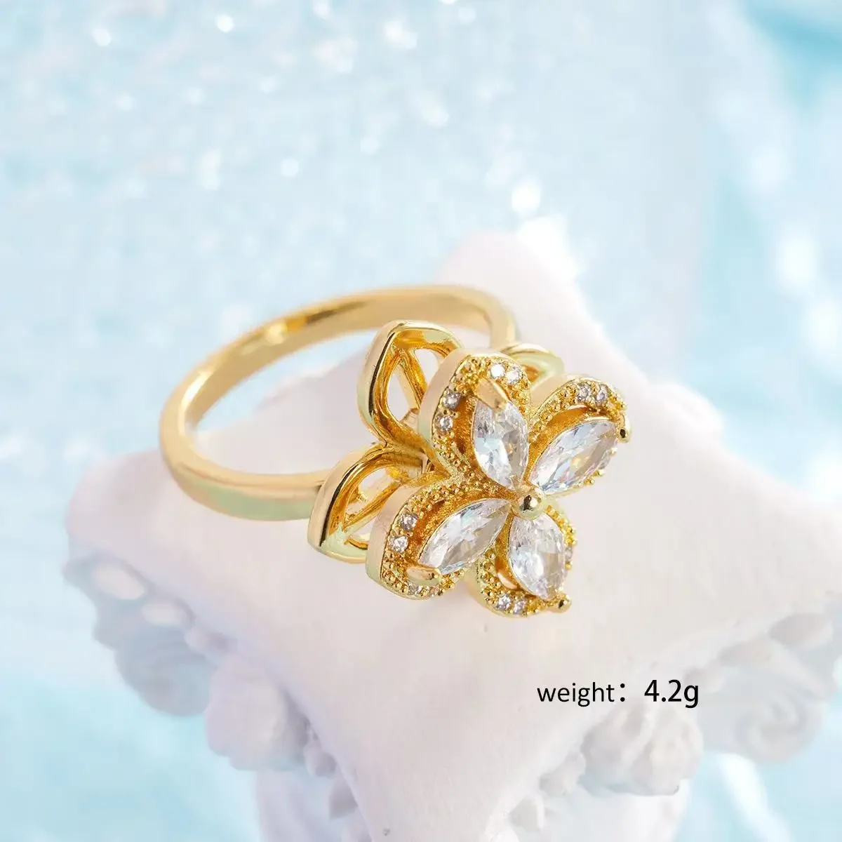 Это вращающееся кольцо с цветком четырехлистного клевера с уникальным женским дизайном и аксессуаром из 100 предметов.