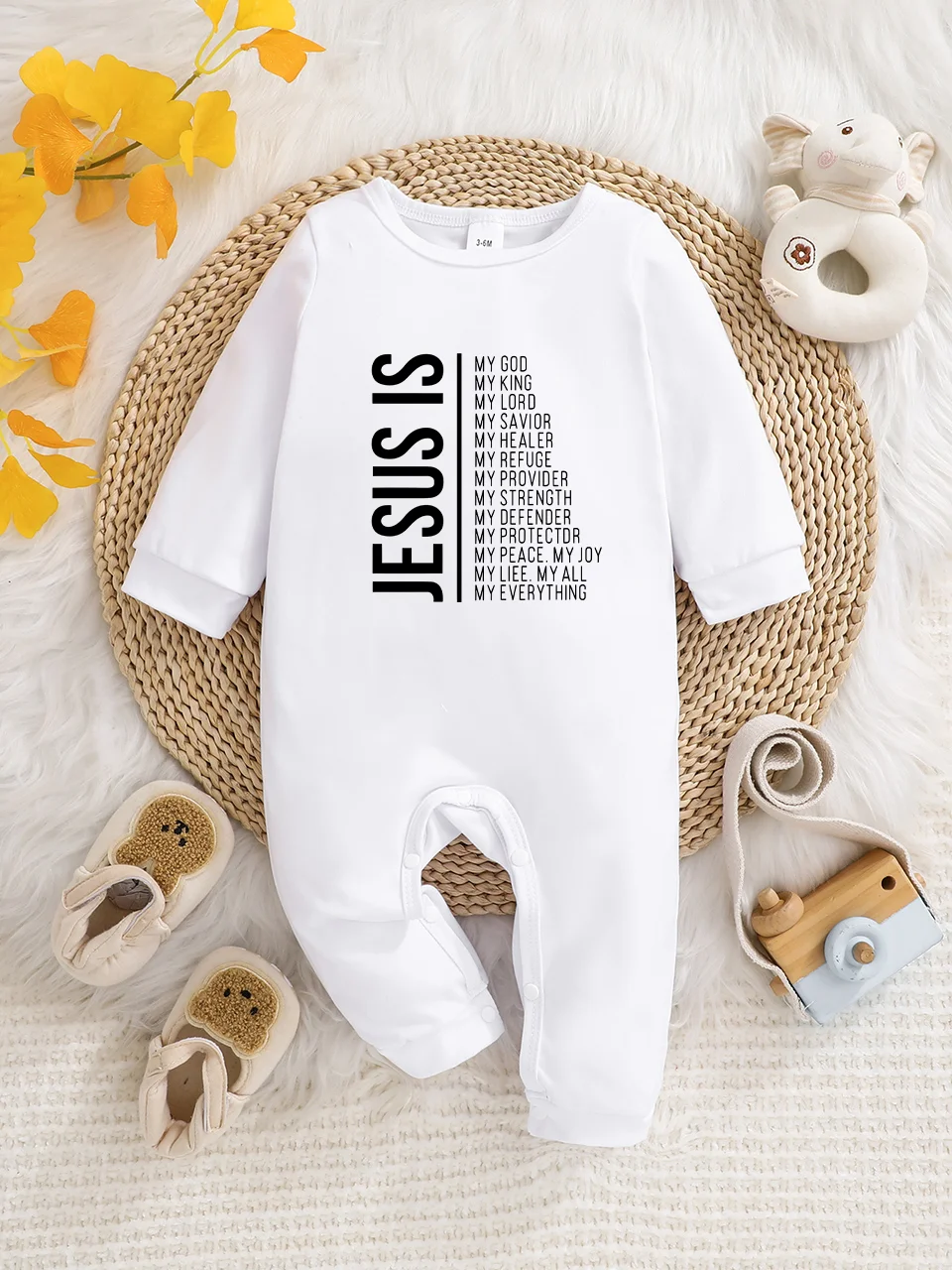 A baby long-sleeved onesie with interesting letter prints. It features a buttoned design for easy putting on and taking off, and