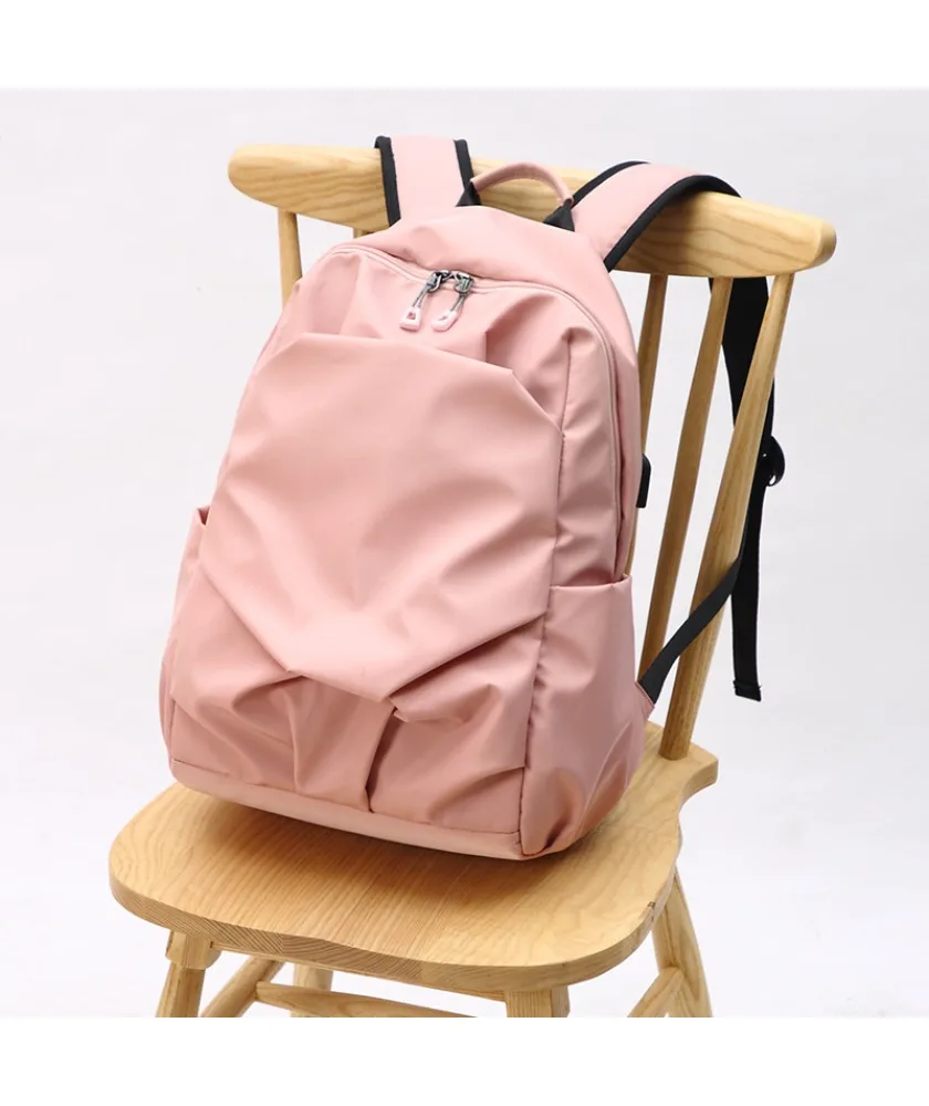 Light gray casual student backpack with orange zipper pulls water resistant fabric dual side slip pockets suitable for daily use