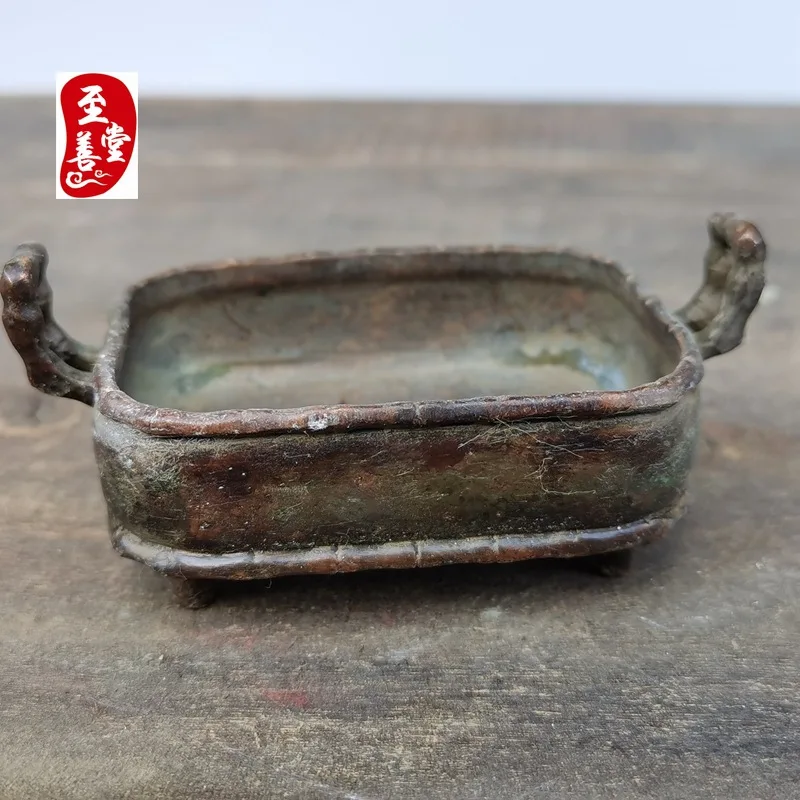 Antique-style copper alloy incense burner with a patina effect, featuring a double-eared, four-legged, square design, suitable f