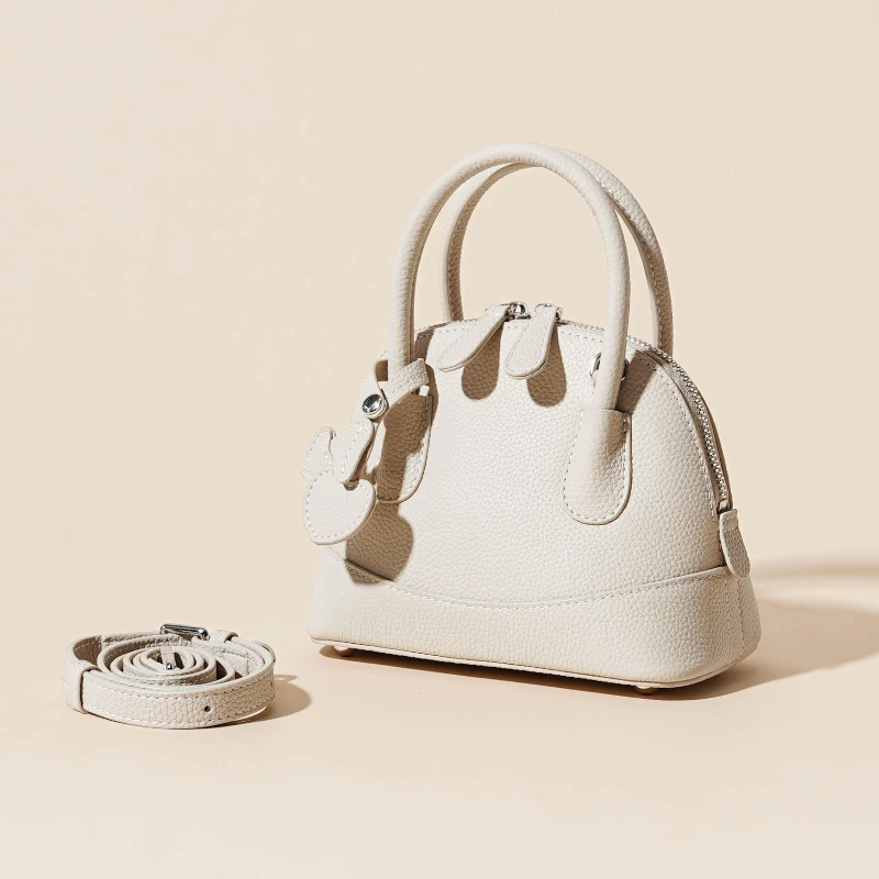 

Small and Exquisite Top-Handle Bag with Litchi Pattern and Heart Clasp-Genuine Leather Bag for Ladies with Unique Design