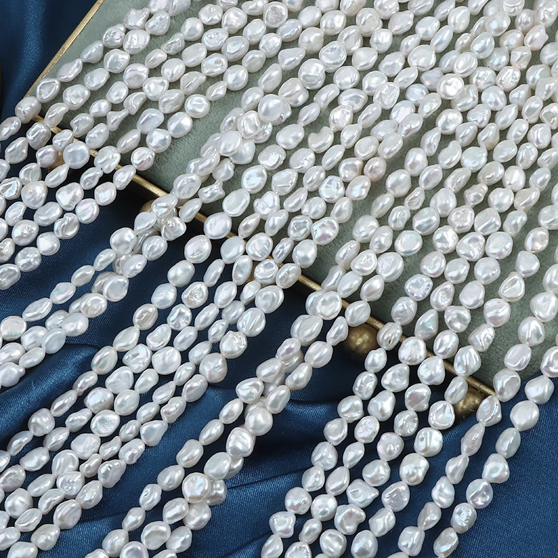 A strand of 5-6mm nucleus-free regenerated bead, broken silver and natural irregular pearls, approximately 39 cm in length.