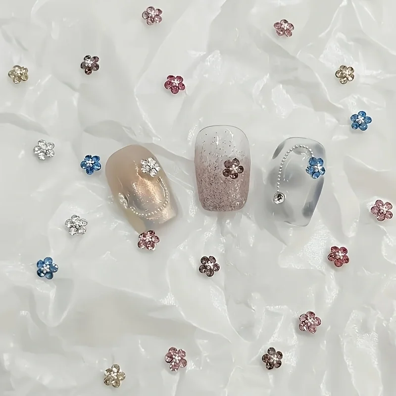A Set of 24 Assorted Nail Embellishments Featuring Mini Five-Petal Diamond Flowers with a Metallic Base, Offering a Three-Dimens