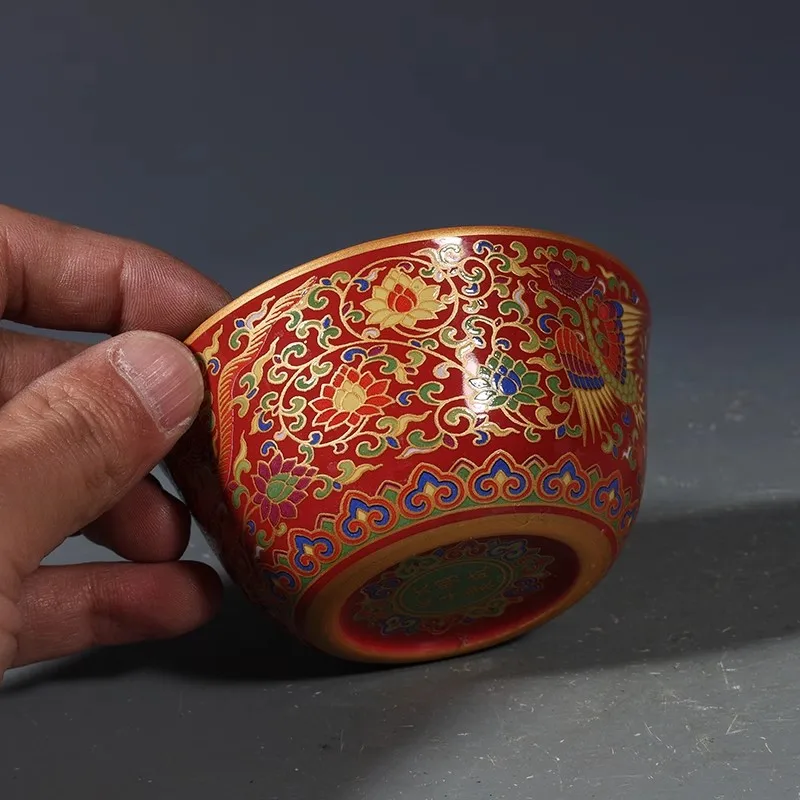 Antique porcelain tea cup with multicolored phoenix pattern and gold tracing from the Ming Dynasty
