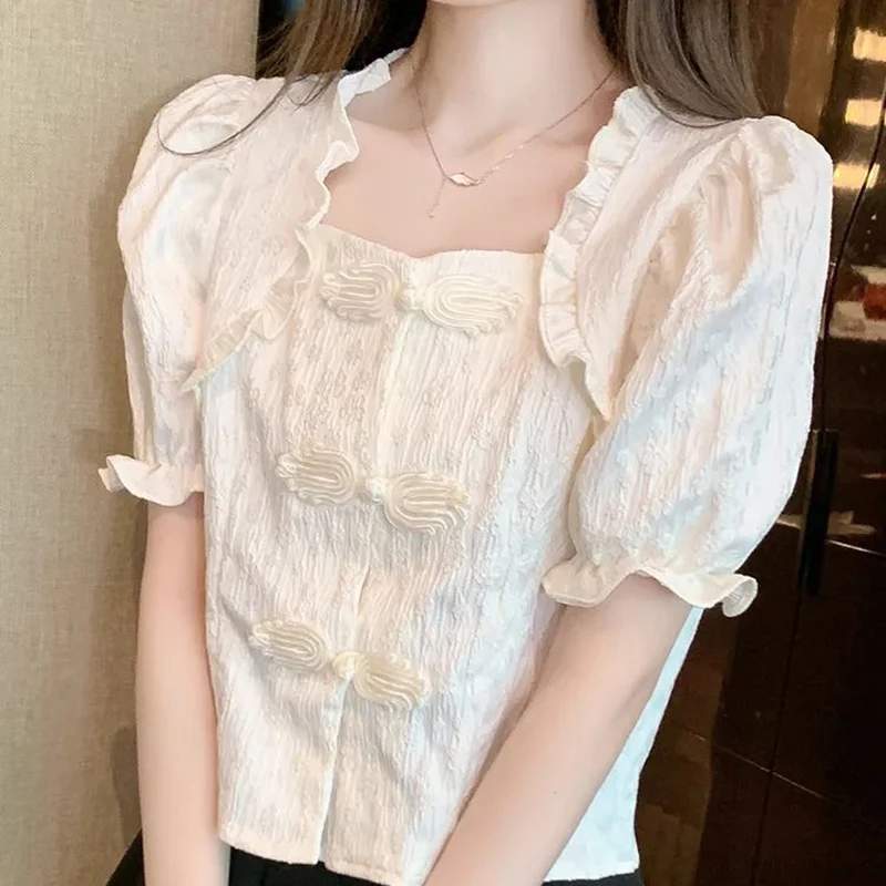 White shirt women's summer design retro buckle wood ear collar shirt chic versatile waist bubble sleeve top.