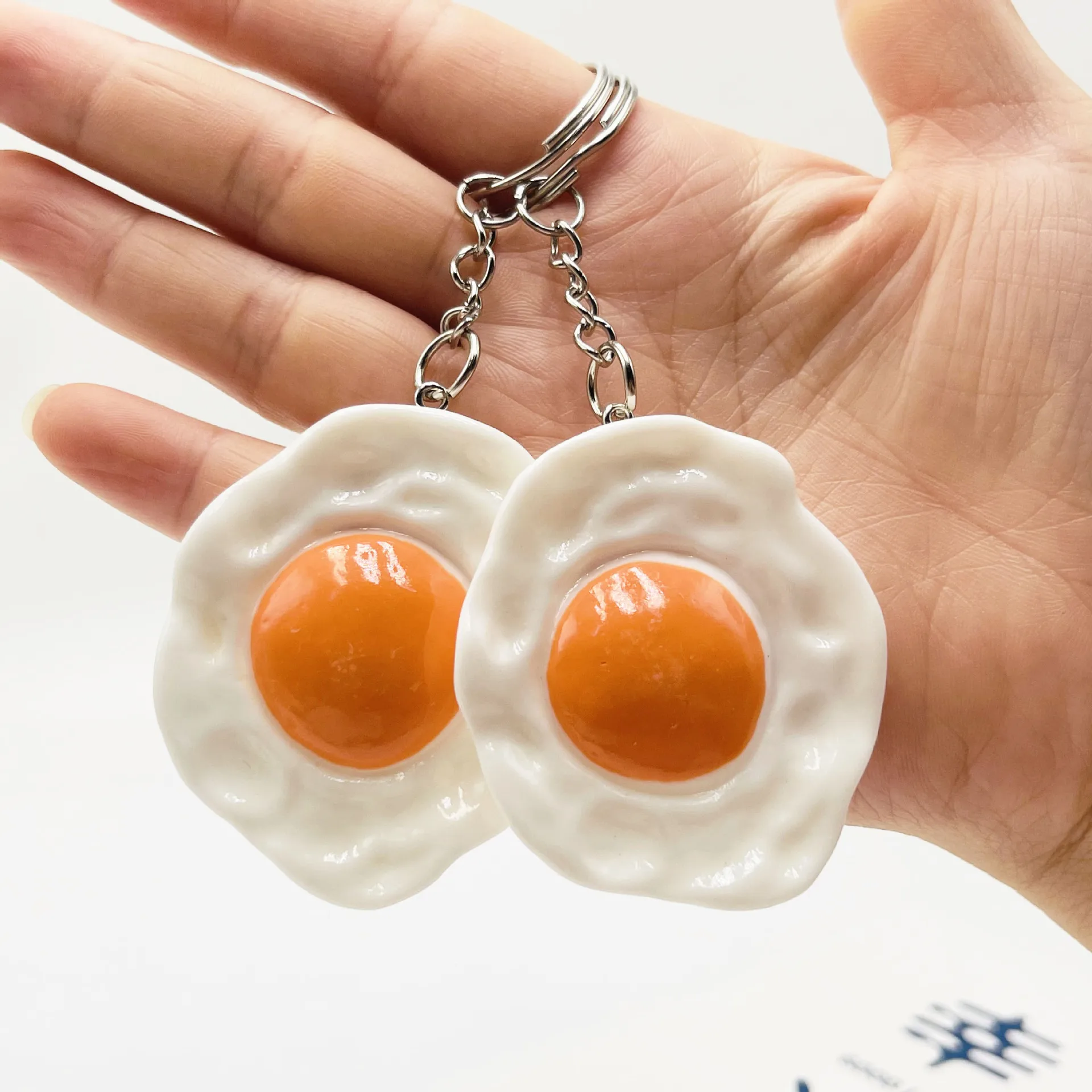 One. New resin egg key chain bag pendant, poached egg pendant promotional gifts spot wholesale. Color random.