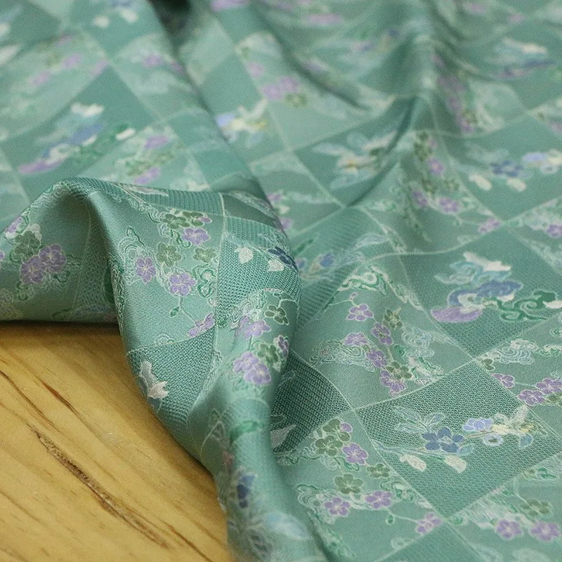 

Spring new style silk jacquard perforated flower fabric printed green base plum blossom traditional Chinese cheongsam