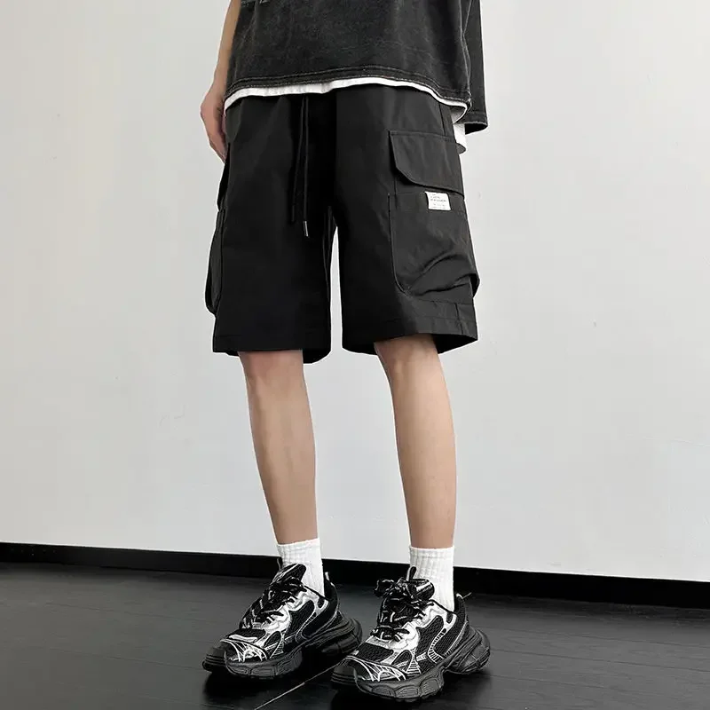 

Эластичная талия Широкие мешковатые свободные бермуды с завязками Мужские короткие брюки Однотонные мужские шорты-карго Длинные черные карманы Jorts