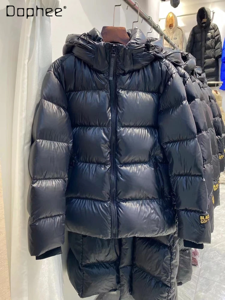 Chaqueta de plumón de ganso con hebilla dorada y negra para hombre y mujer, abrigos cortos con capucha de manga larga cálidos para pareja, de alta
