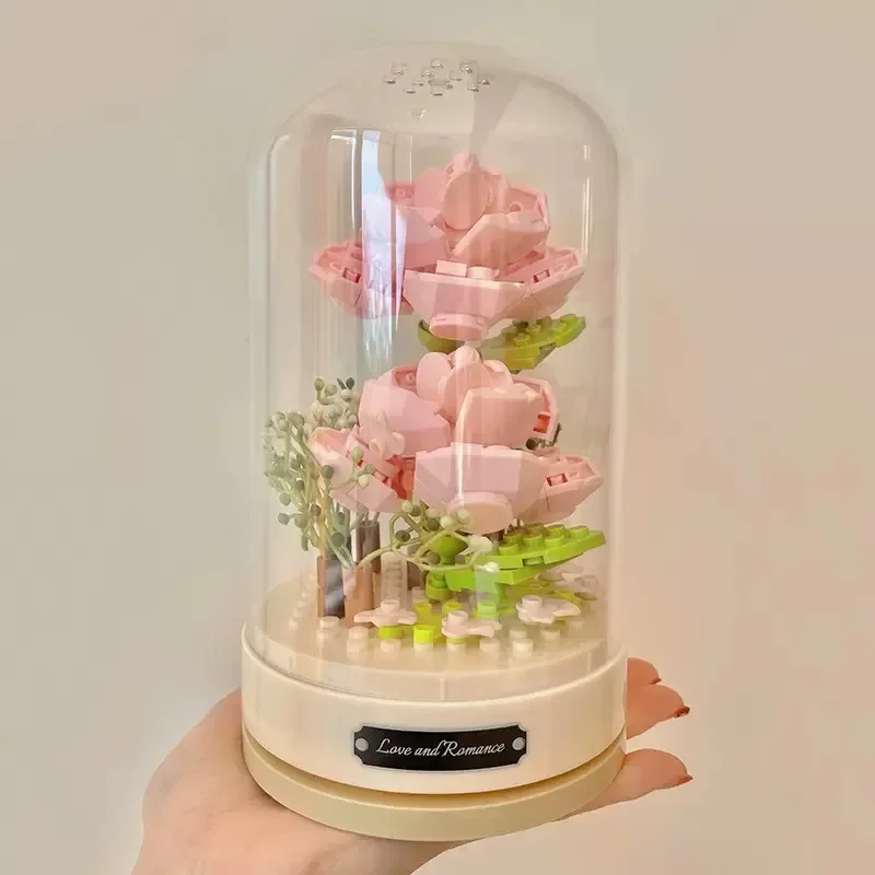Building blocks music box Clockwork rotating music box Building blocks Rose Lily of the valley puzzle set Valentine\'s Day gift