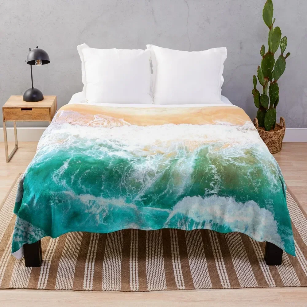 The hot sand of a tropical beach cooled by the blue waves of the cold ocean Throw Blanket