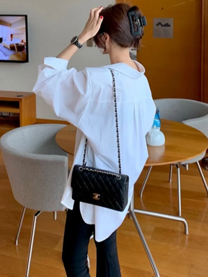 เสื้อยืดแฟชั่นลำลองผู้หญิงสไตล์ชิคต้นฤดูใบไม้ร่วงหลวมแขนยาวคอตั้งไม่สมมาตรด้านข้างผ่าด้านข้าง