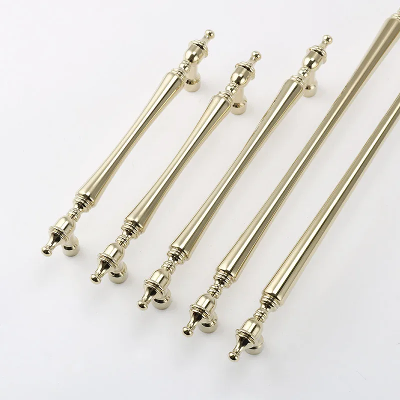 Slender gold bar handles with shaped finials