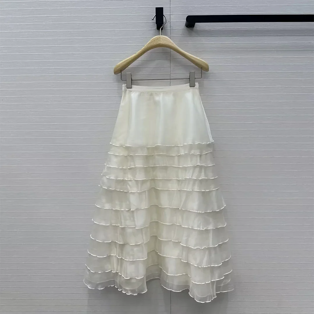 

Высококачественная юбка-миди для женщин на весну и лето 2026 года. Посмотрите внимательно на элегантную отделку с многослойными рюшами.