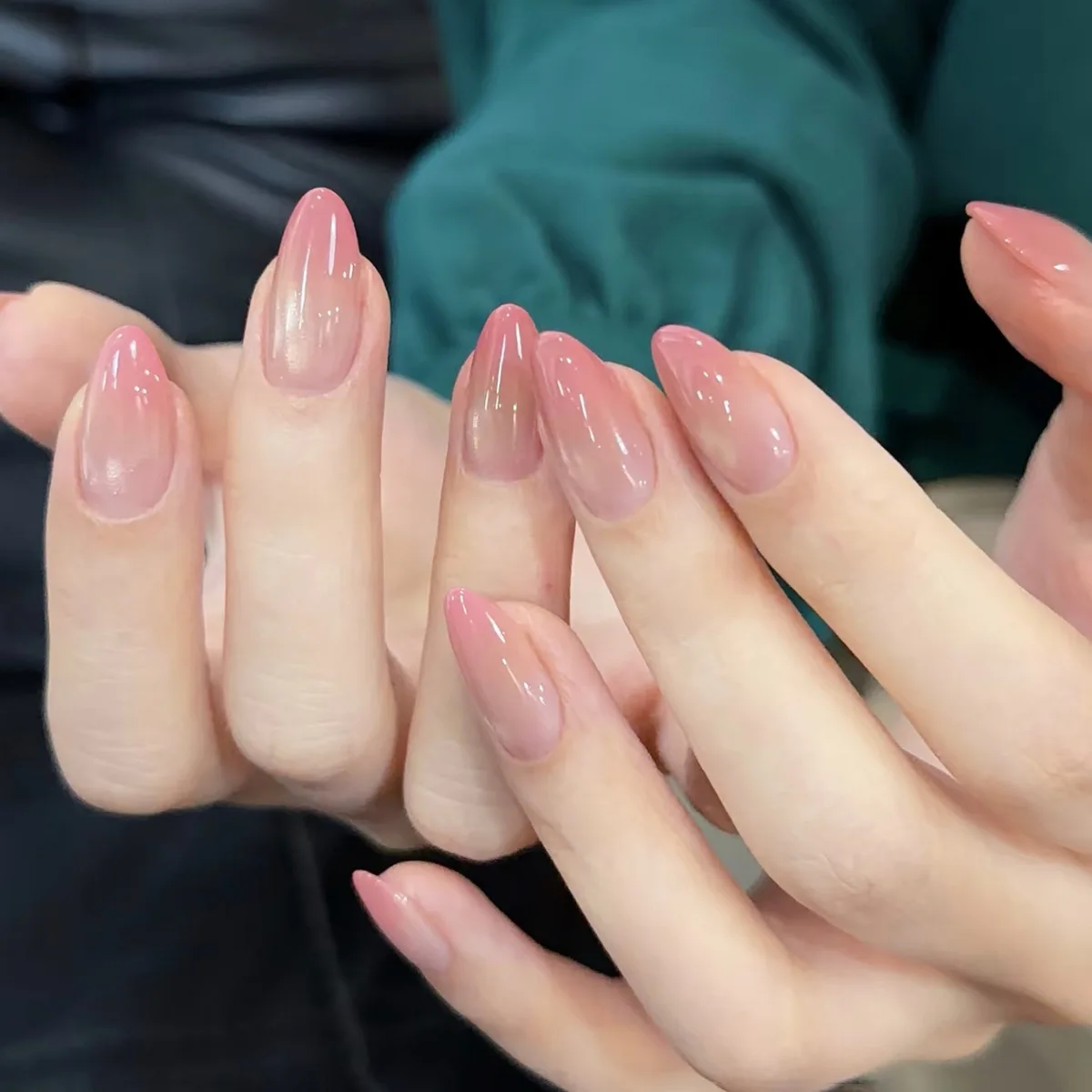 24pcs handmade almond press-on nails. Clear nude fading into peach pink gradient, minimalist blush design. Reusable, ideal for d