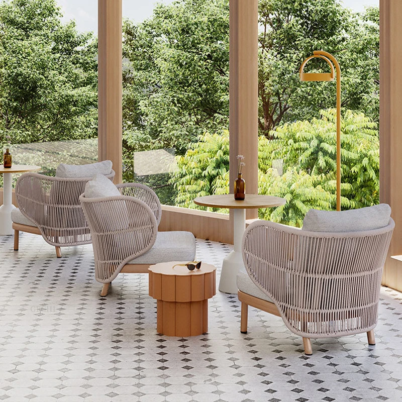 Modern outdoor patio sofa and chair set, woven with rattan, designed to be durable and weather-resistant, suitable for courtyard