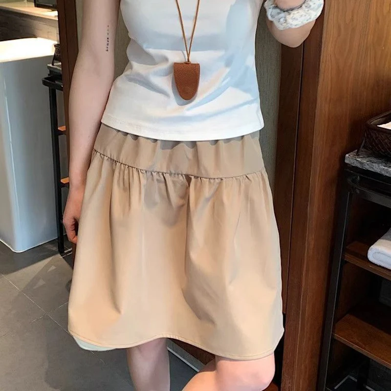 

Летние женские юбки А-силуэта 2026 года: шикарные темно-синие ретро-модели с завышенной талией, тонкие миди-юбки, модные однотонные платья средней длины для девушек