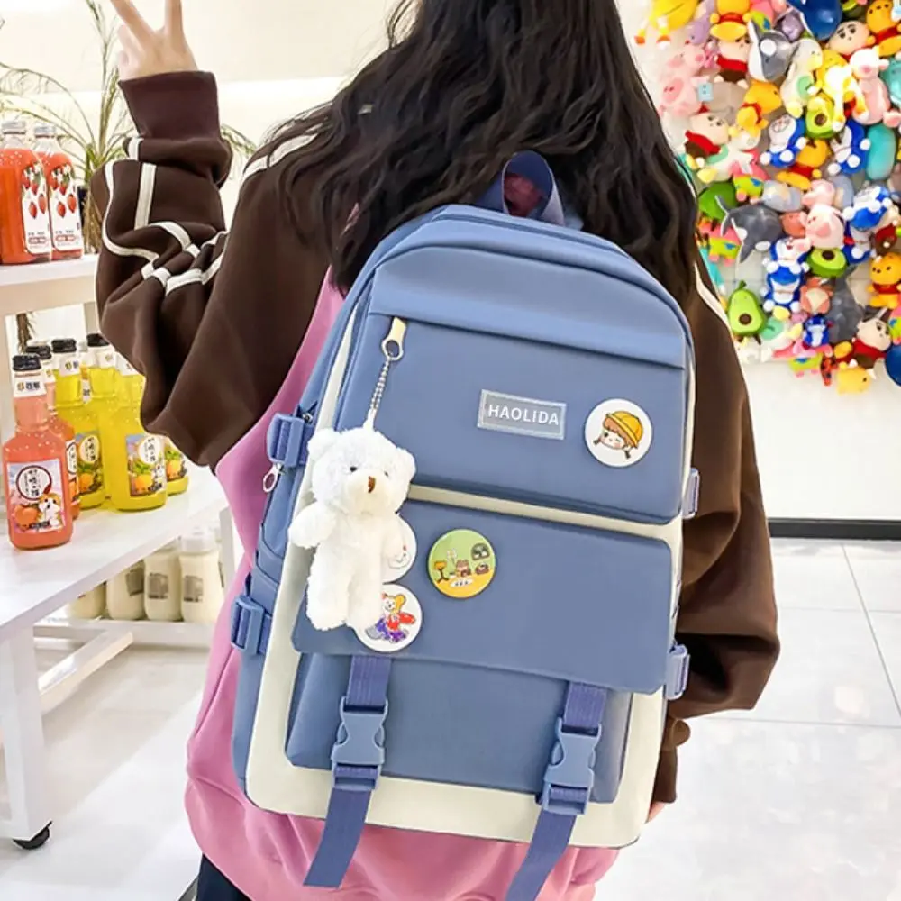 Mochila de gran capacidad de nailon para niños, bolso de lona con insignia de viaje, mochila de hombro, un conjunto de cuatro mochilas escolares simples de estilo coreano