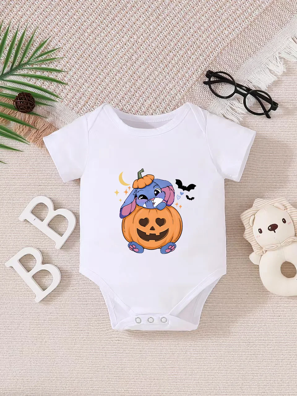 

Playful letter-printed baby short-sleeve triangle bodysuit. Button closure for easy dressing, machine washable