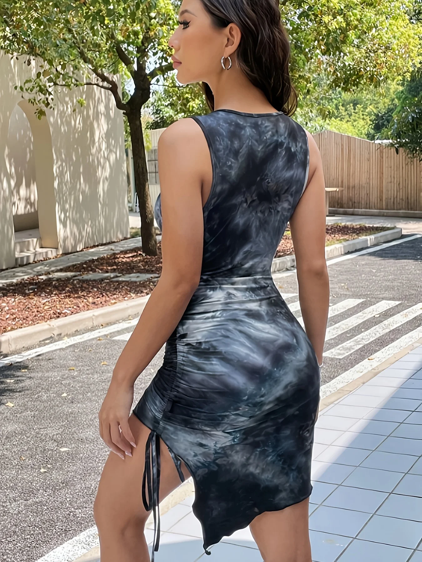 A lady's blue tie-dye dress with dreamy and ethereal appearance, featuring a plunging round-neck and drawstring design.