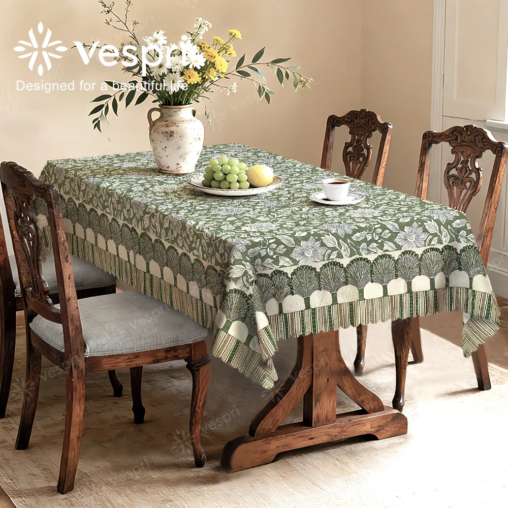 Vespri Spring Tablecloth, with green and white patterns, featuring green leaves and stripes.