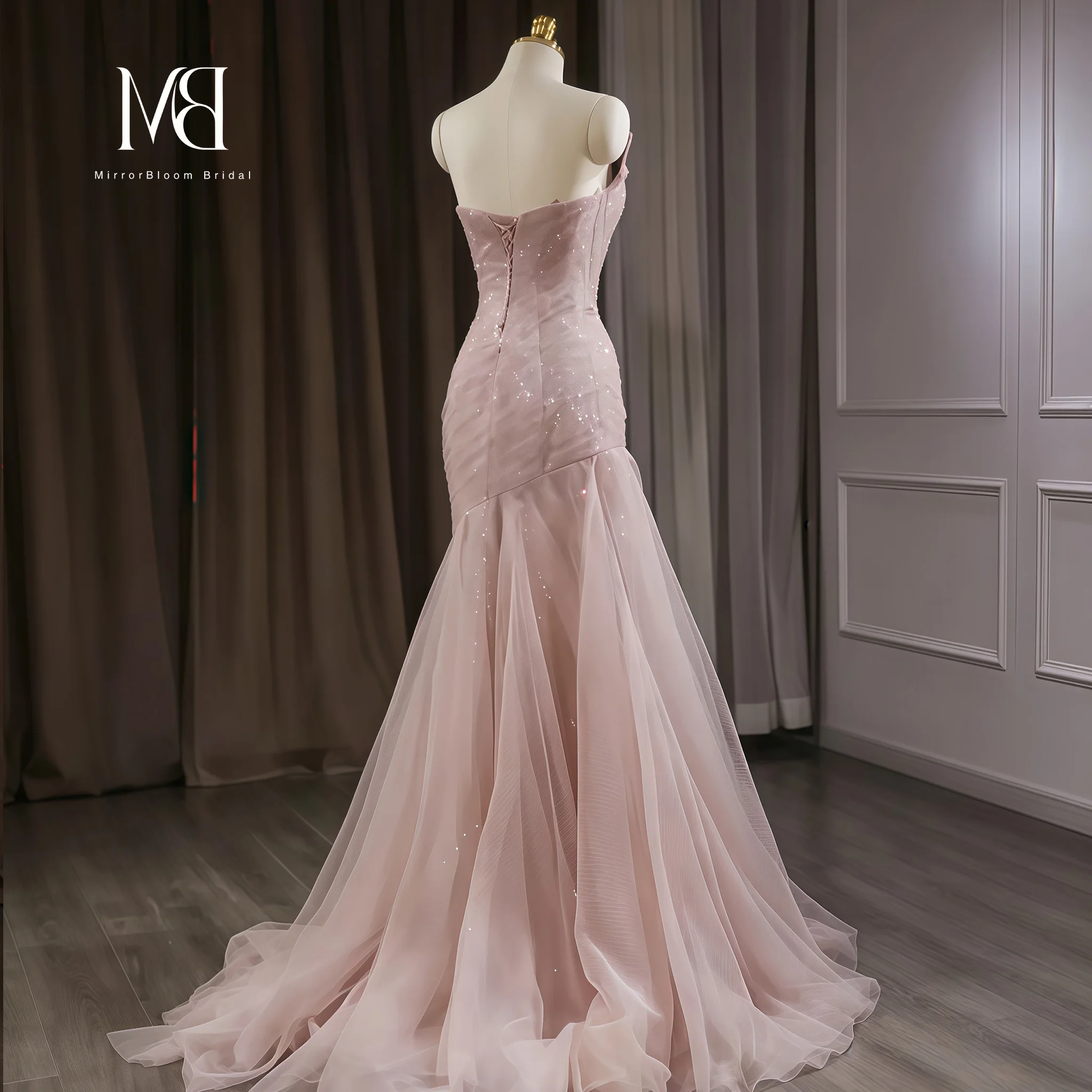 Elegant pink strapless mermaid-style formal gown featuring a shimmering tulle skirt