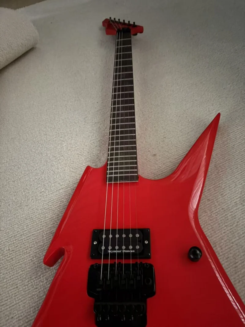 A large red lightning-shaped 6-string guitar with rosewood fretboard, black tremolo bridge, high-gloss finish, free delivery