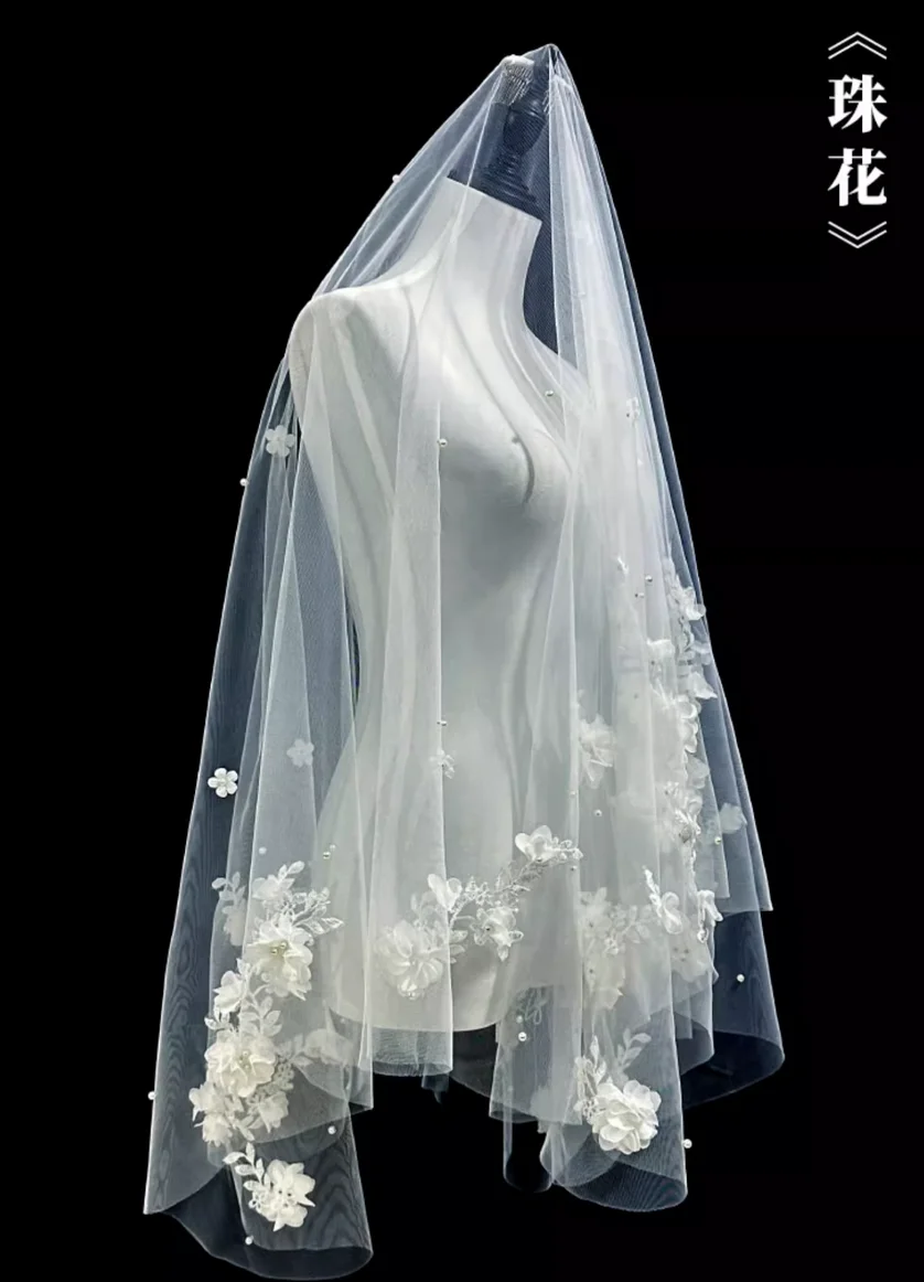 The bride's wedding veil is an ethereal, forest-inspired lace and floral design, perfect for wedding registration and photoshoot