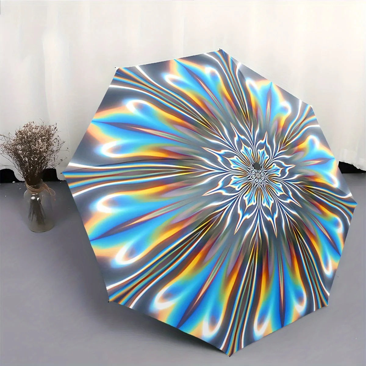 

Automatic Folding Umbrella Radiating rainbow-like streaks forming a floral pattern. Portable collapsible design, casual outdoo