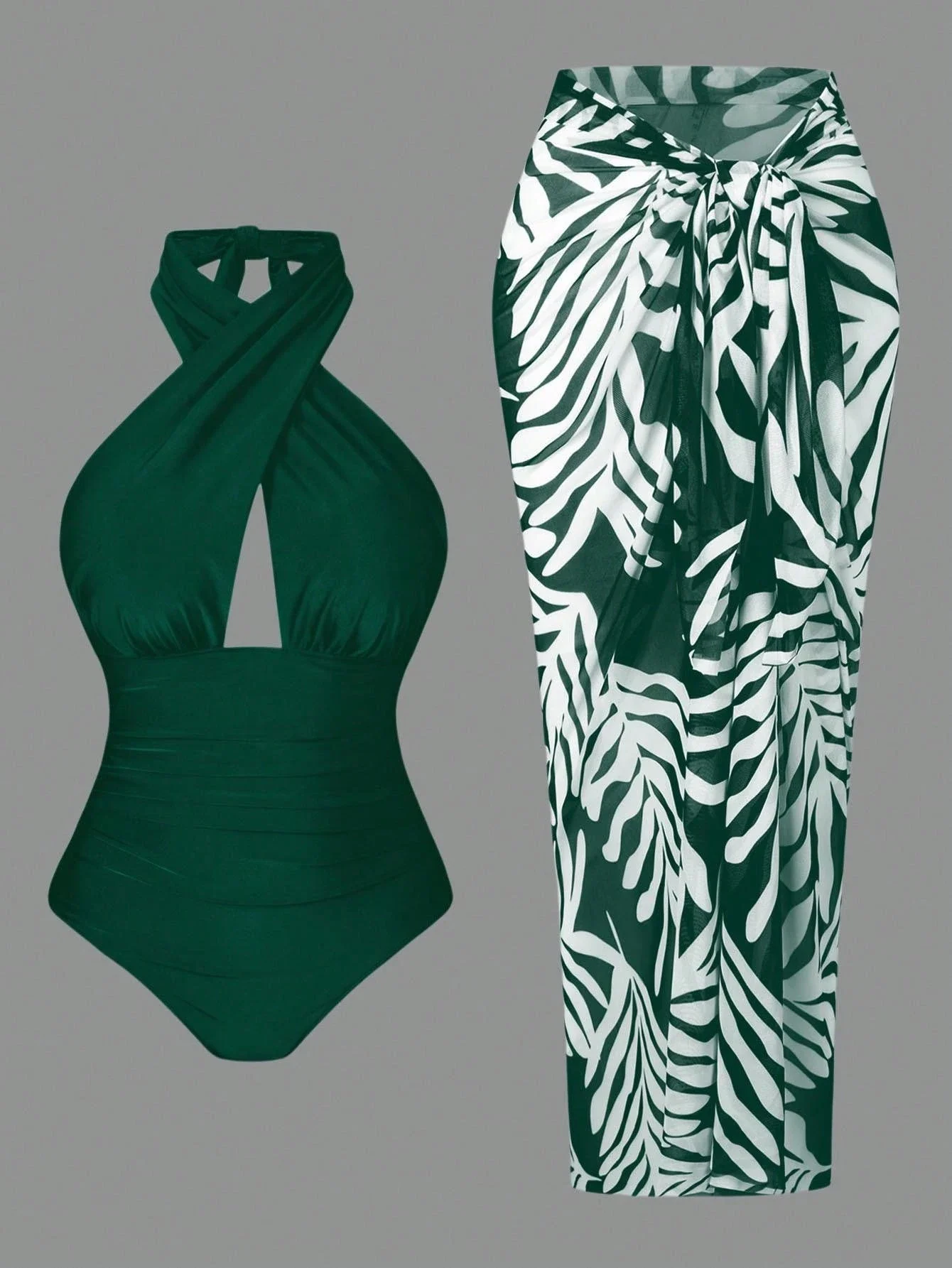 

Изумрудно-зеленый слитный купальник с перекрестными бретелями в комплекте с юбкой-парео с тропическим принтом для пляжного отдыха и поездок на бассейн.