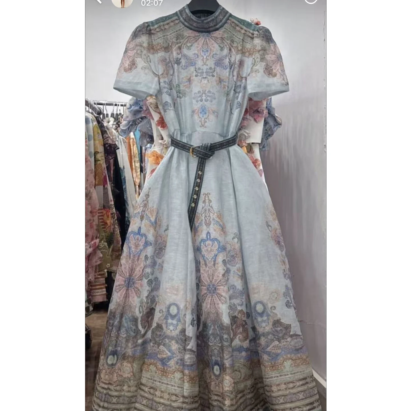 

A 2025 fashion trend: short, medium-long, belt-cinched dress with halter straps