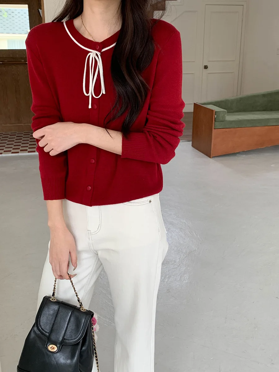 Kardigan rajut leher bulat dengan dasi kupu-kupu desain baru awal musim gugur.