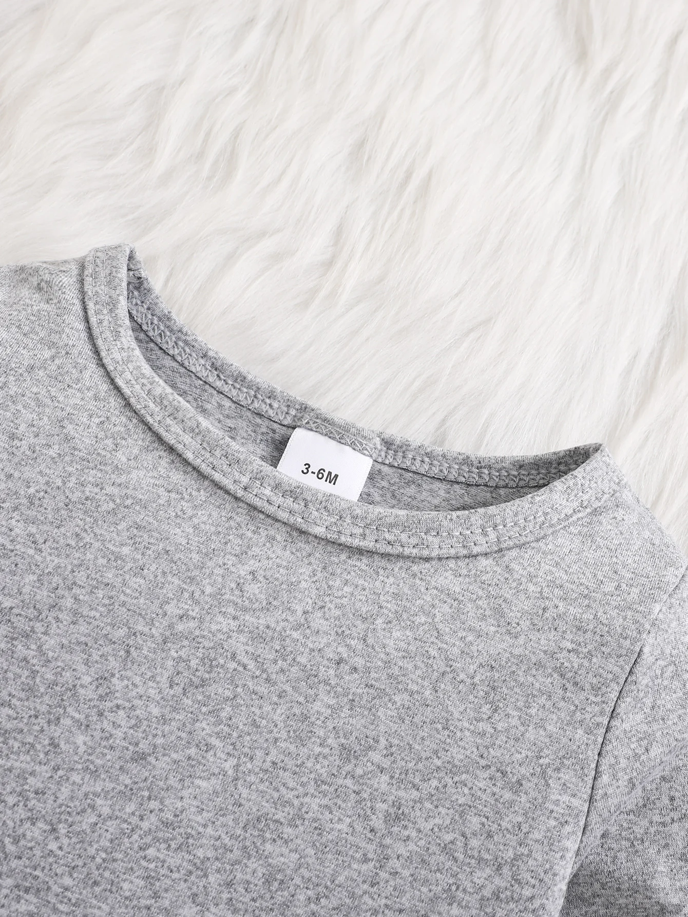 A baby long-sleeved onesie with interesting letter prints. It features a buttoned design for easy putting on and taking off