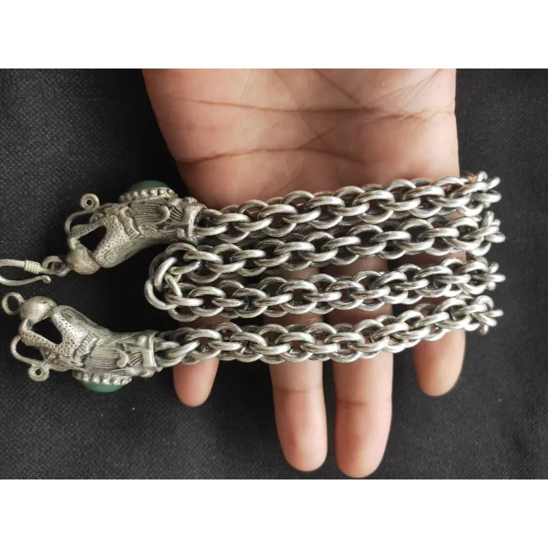 A classic handmade bracelet made of Tibetan silver dragon head necklace inlaid with jade and stones, a holiday gift for friends