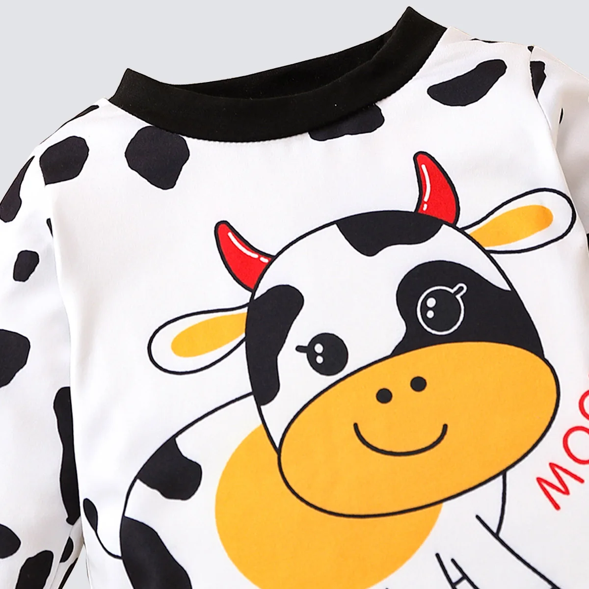 Two piece cute and fashionable black and white spotted cow print long sleeved round neck top and pants set for baby boys