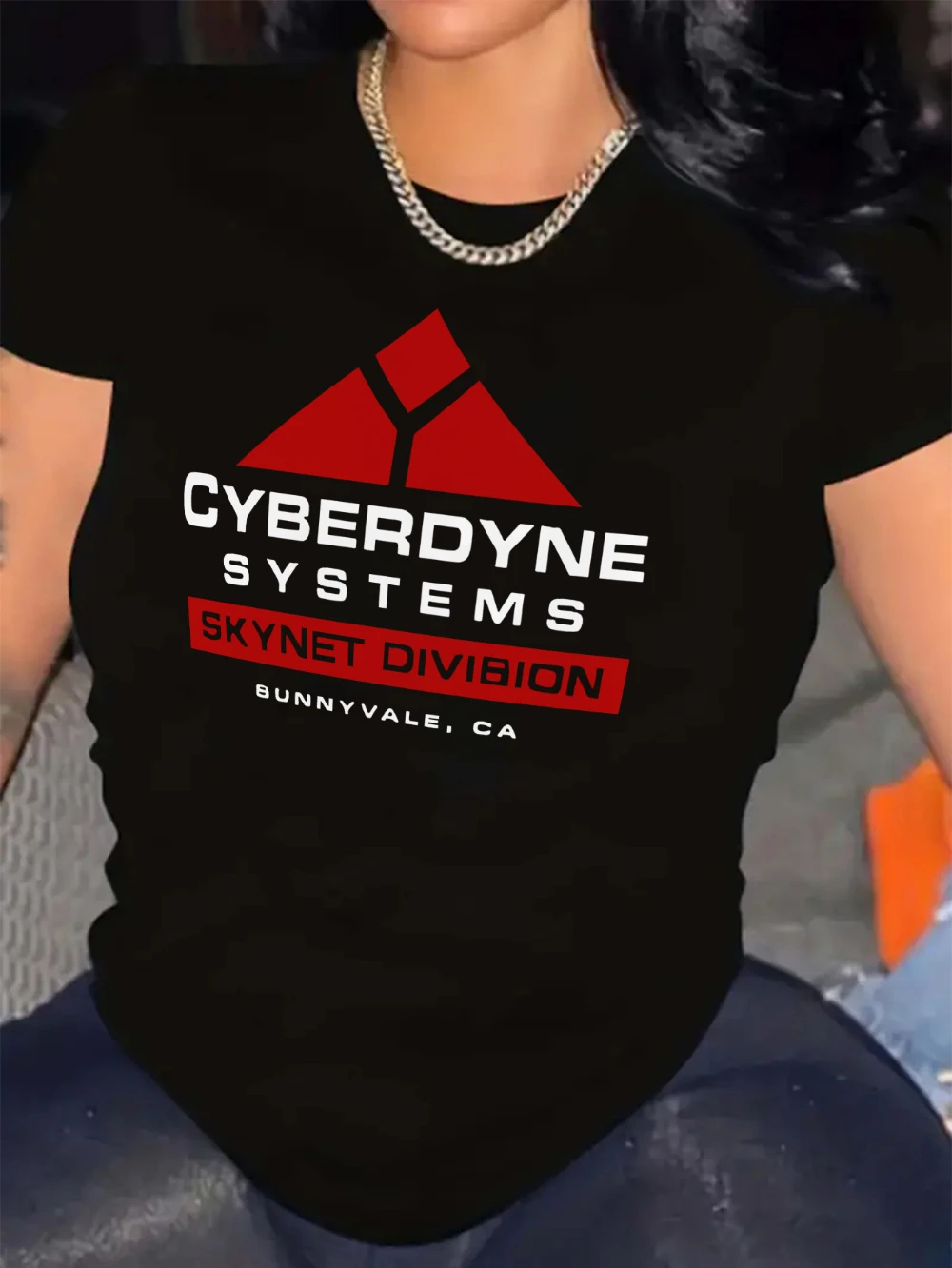 The black T-shirt features a red and white Cybernet system graphic with a triangular design and the word 