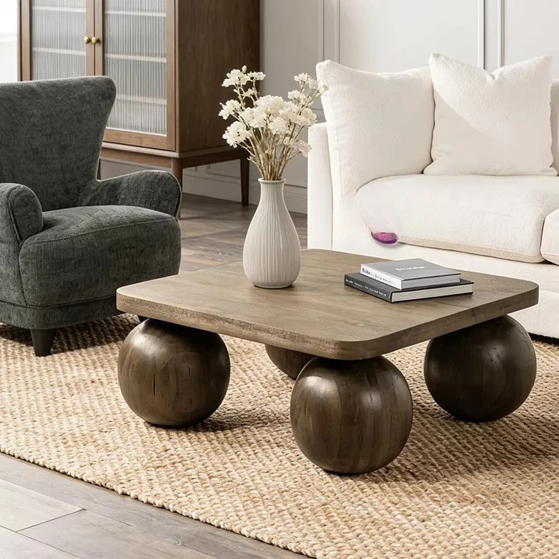 

Solid wood square table with spherical legs and natural wood grain finish for a modern living room in a rustic style
