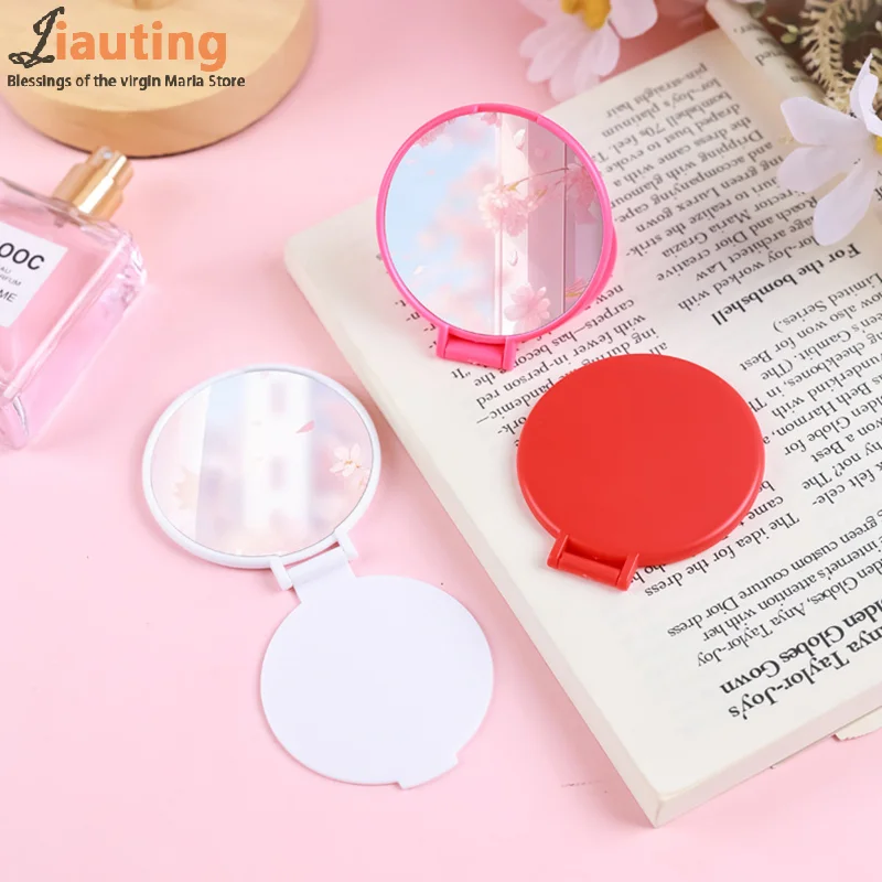 กระจกแต่งหน้า HD แนวตั้งทรงกลมแบบพกพาพับได้กระจกตั้งโต๊ะแบบใช้คู่แนวตั้งราคาไม่แพงนักเรียนจับกระจกแต่งหน้า