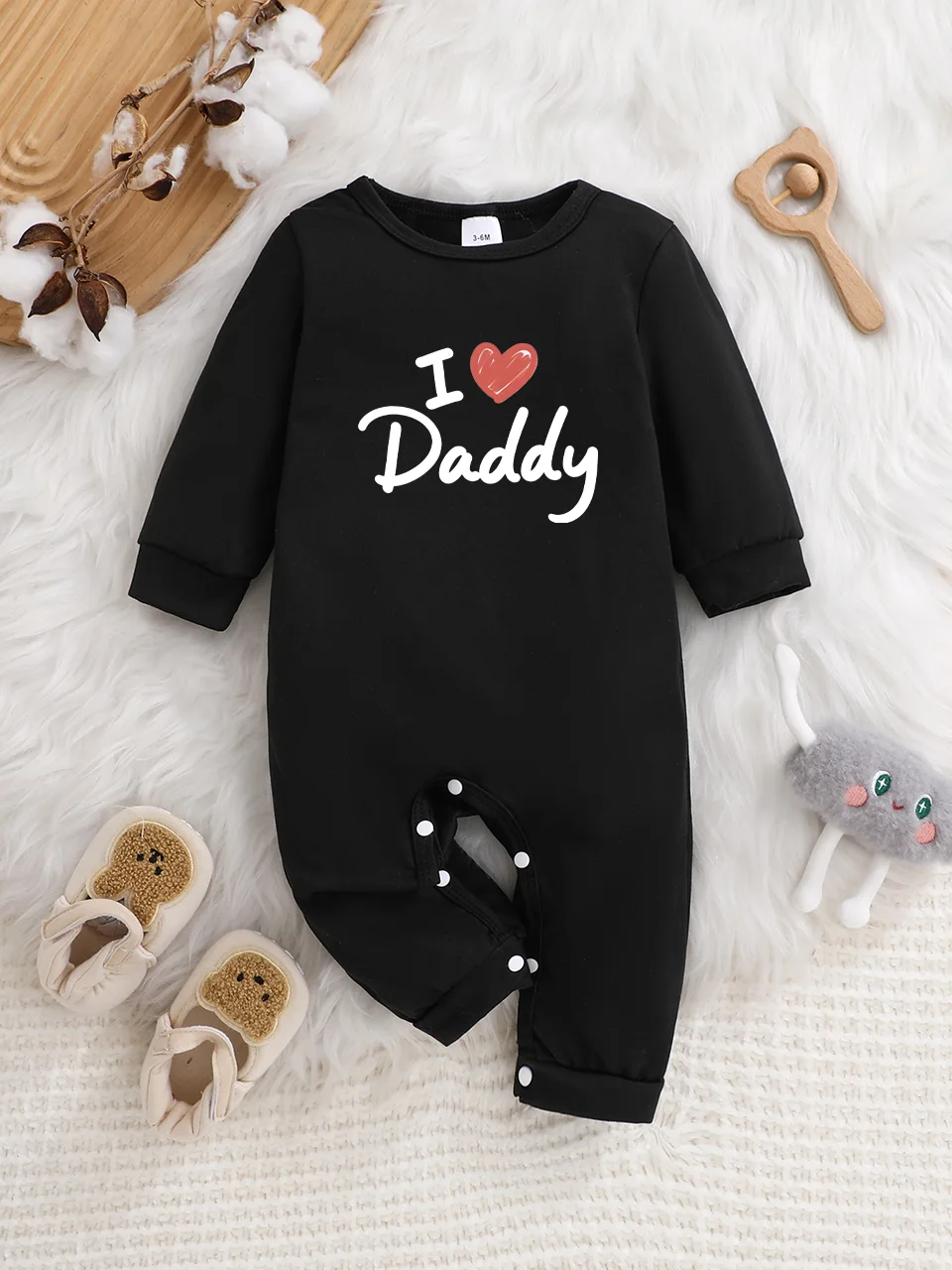A baby long-sleeved onesie with interesting letter prints. It features a buttoned design for easy putting on and taking off