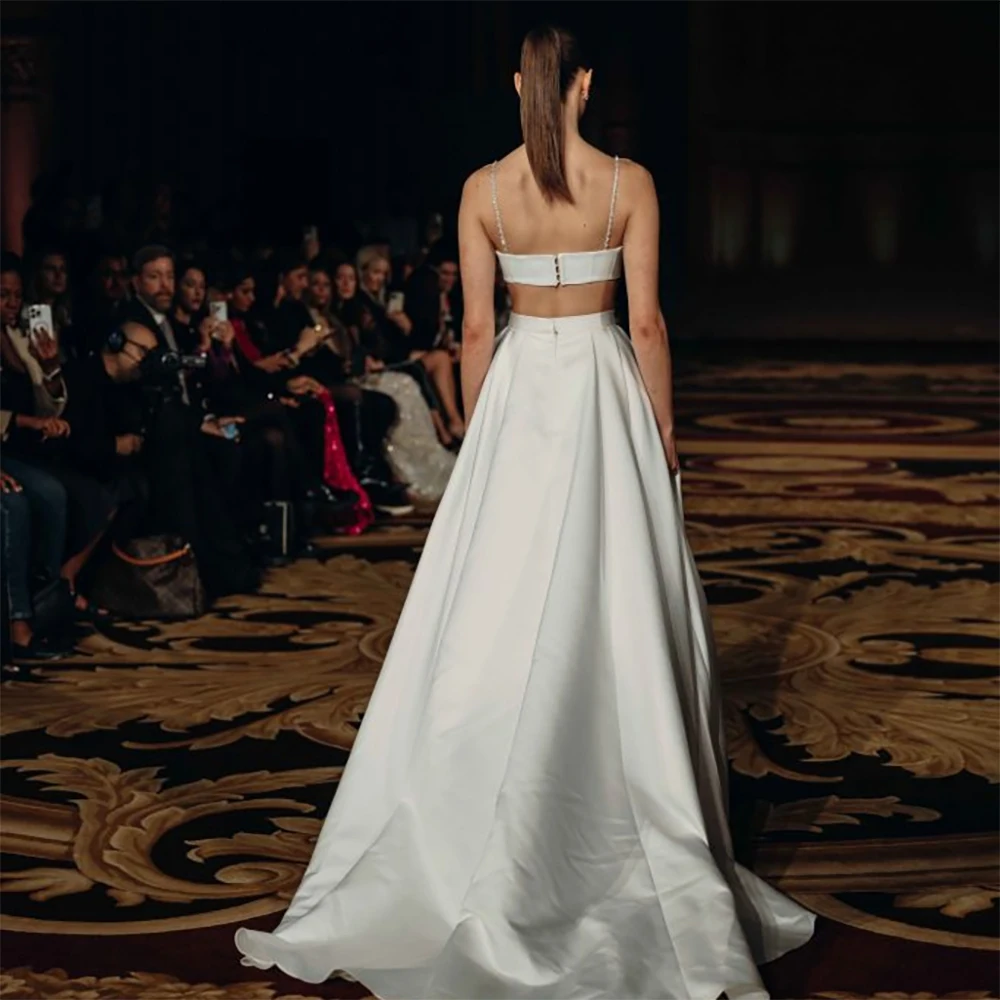 2026 Luxury Satin Wedding Dress Crystal Spaghetti Strap Cutout Waist Button Front A-Line Bridal Gown with Pockets for Ceremony