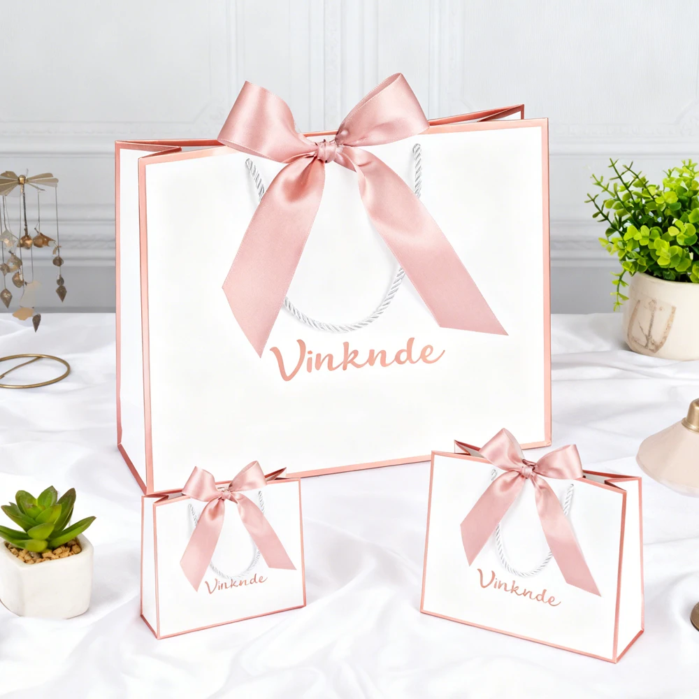 

24pcs 19x15x7cm Luxury Custom White Pink Kraft Paper Packaging Gift Bags with Bow Ribbon Handles for Clothing Personalized Logo