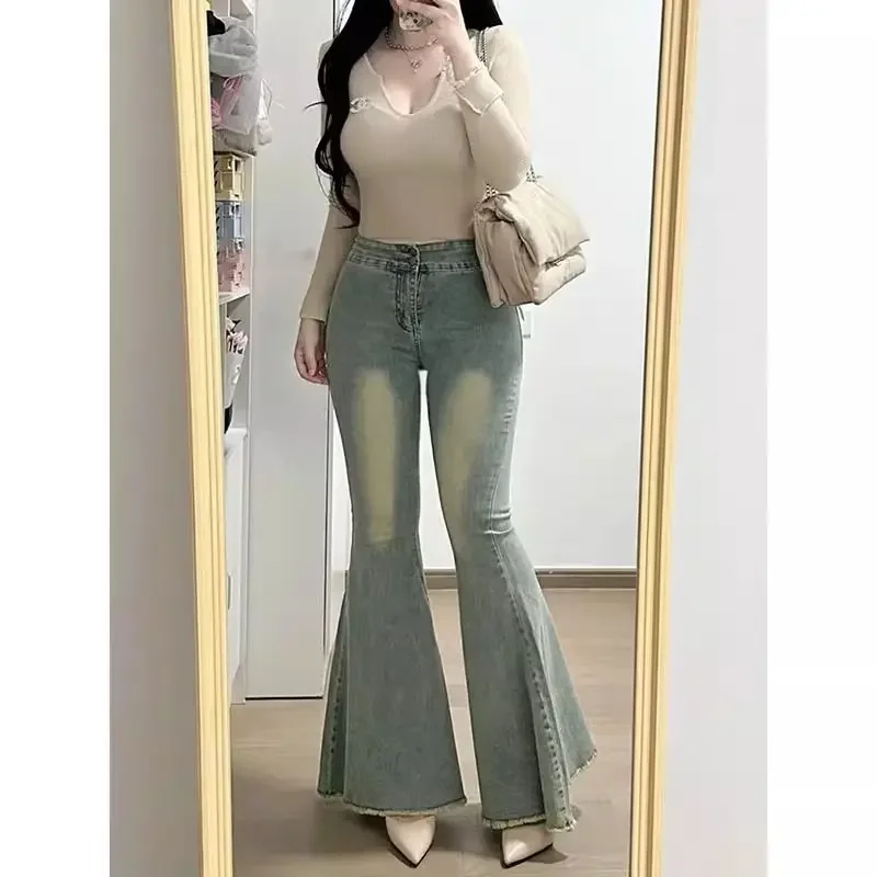 Retro fishtail flared jeans female autumn and winter new slim elastic fashion temperament wide-leg pants with raw edges.