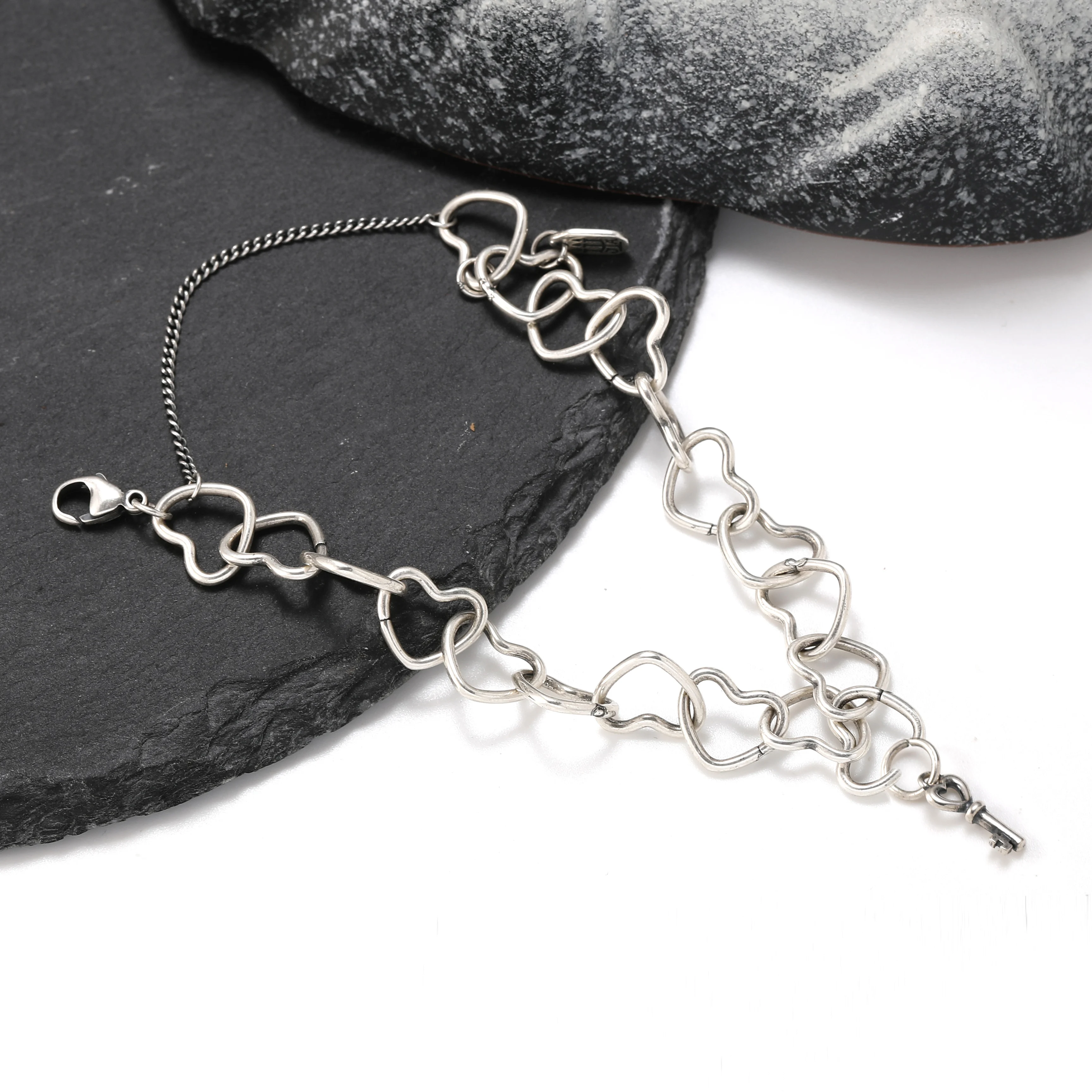 

Genuine 925 sterling silver Connected Hearts Charm Bracelet paired with Mini key pendant